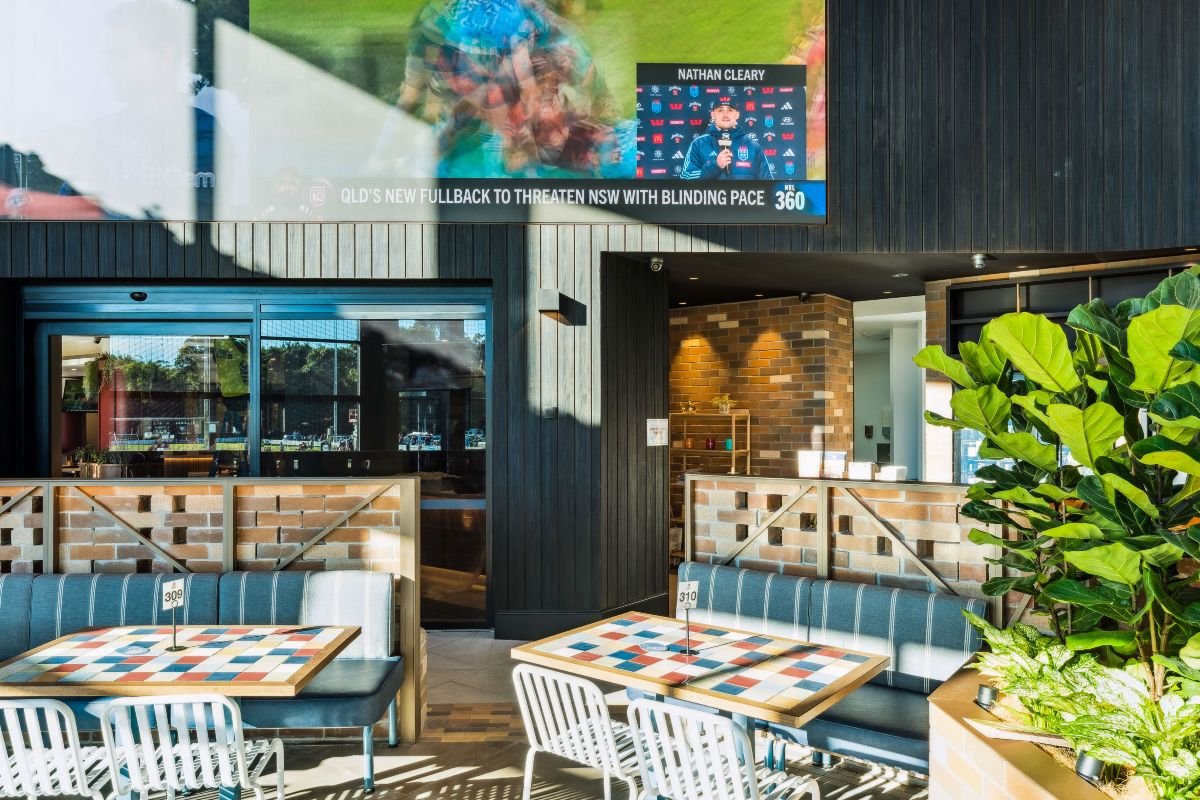 Modern restaurant featuring artificial plants and hanging greenery
