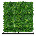 A square artificial green foliage wall panel mounted on a black metal stand, photographed against a plain white background.