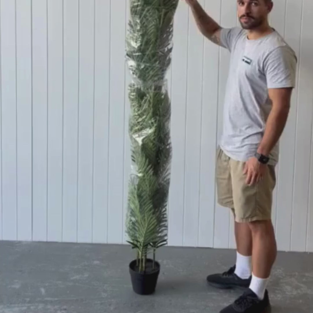 Unboxing an artificial greenery plant at Evergreen Walls Warehouse